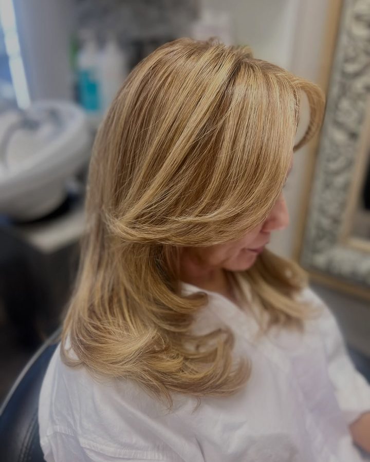 Golden blonde color with soft face-framing layers